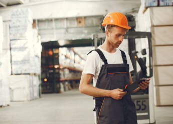 industrial-worker-indoors-factory-young-technician-with-orange-hard-hat