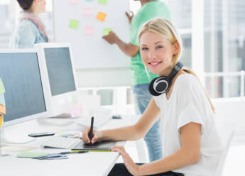 artist-drawing-something-graphic-tablet-with-colleagues